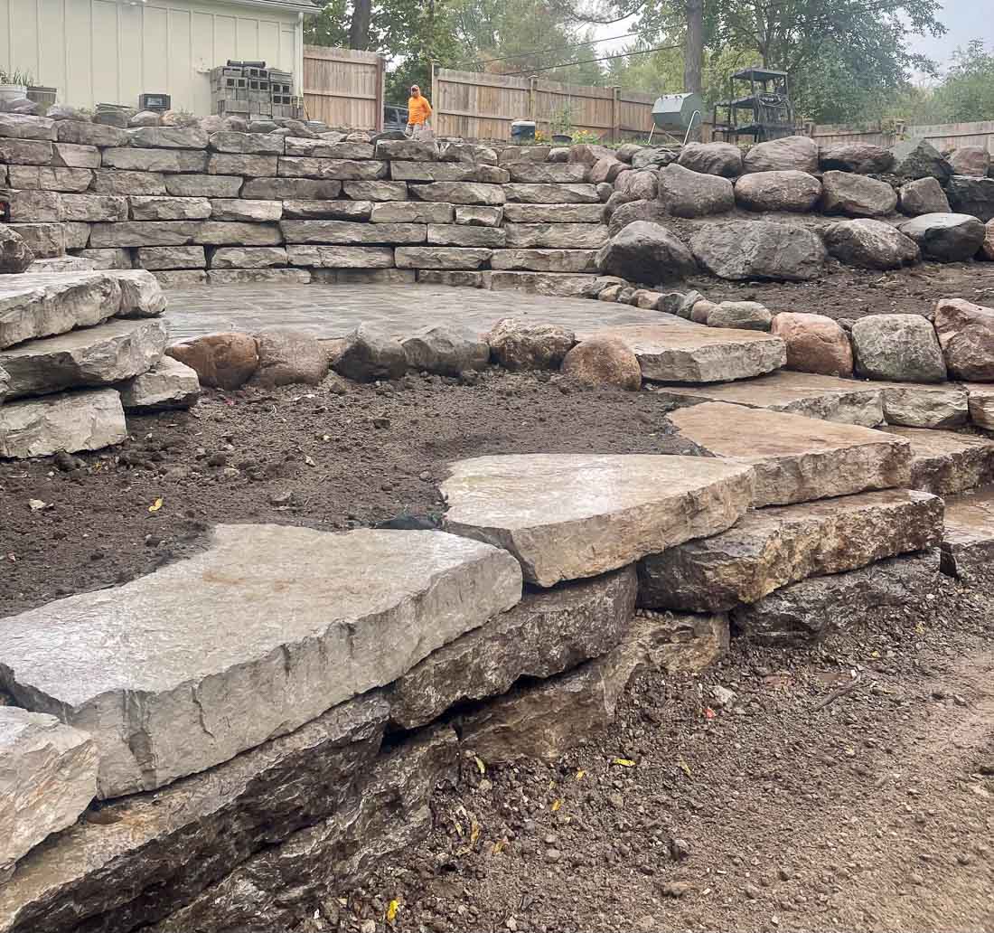 large format stones being placed to create retaining wall